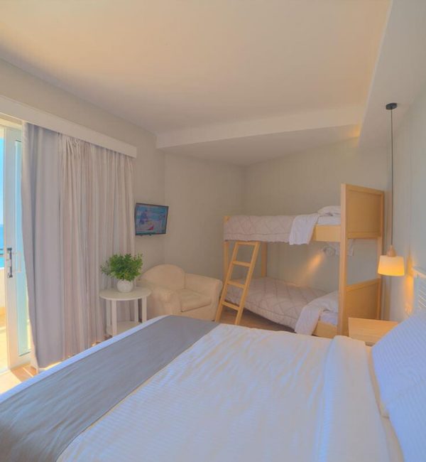 Elea Beach Family Accommodation Room with a double bed and a bunk